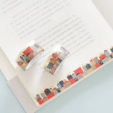 two rolls of gold foiled top quality washi tape displayed on an open book