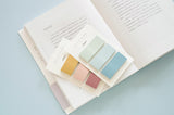 two sticky notes sets displayed on an open book