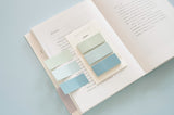 cool colour sticky notes displayed on an open book with three sticky notes applied on the page