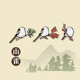 three titmouse on branches enamel pins displayed in a row over a traditional chinese art background