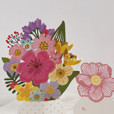 3d pop up greeting card of a bunch of flowers in a vase displayed on a white surface detailed view on flowers